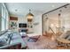 Stylish living room featuring hardwood floors, built-in shelving, a modern light fixture, and glass-enclosed entry at 114 Trinity Hollow Dr, Canton, GA 30115