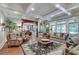 Spacious living room with coffered ceiling, hardwood floors, and an open layout leading to the dining area at 114 Trinity Hollow Dr, Canton, GA 30115
