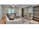 A cozy living room with a large rug, comfortable seating, and mirrored sliding bookshelves at 114 Trinity Hollow Dr, Canton, GA 30115