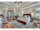 Spacious main bedroom with tray ceiling, hardwood floors and outdoor patio access at 114 Trinity Hollow Dr, Canton, GA 30115
