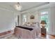 Comfortable main bedroom with many windows, a decorative rug, and soft natural lighting at 114 Trinity Hollow Dr, Canton, GA 30115