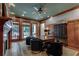 Executive office featuring a large wood desk, wood paneling, fireplace and backyard views at 114 Trinity Hollow Dr, Canton, GA 30115