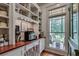 Well-organized pantry with open shelving, wooden countertops, and a window with a view of the backyard at 114 Trinity Hollow Dr, Canton, GA 30115