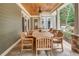 Covered patio with beautiful stone flooring, ceiling fan and outdoor dining at 114 Trinity Hollow Dr, Canton, GA 30115
