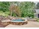 Backyard pool area complete with stone landscaping and lush foliage at 114 Trinity Hollow Dr, Canton, GA 30115
