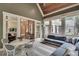 Sunroom with vaulted ceiling, outdoor views, and comfortable seating area at 114 Trinity Hollow Dr, Canton, GA 30115