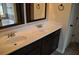 Bathroom featuring double sinks with dark wood cabinets and elegant countertops at 1530 Horseshoe Creek Ln, Cumming, GA 30041