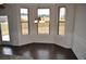 Open-concept dining area with three windows, hardwood floors and modern wainscoting next to outside door at 1530 Horseshoe Creek Ln, Cumming, GA 30041