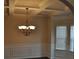 Elegant dining room featuring a coffered ceiling, decorative chandelier, and large bright windows at 1530 Horseshoe Creek Ln, Cumming, GA 30041