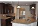 Modern kitchen featuring granite countertops, stainless steel appliances, and dark wood cabinetry at 1530 Horseshoe Creek Ln, Cumming, GA 30041