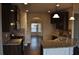 Well-appointed kitchen with granite counters, dark cabinets, stainless appliances and open to adjacent living areas at 1530 Horseshoe Creek Ln, Cumming, GA 30041