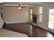 Spacious living room with hardwood floors, stone fireplace, and abundant natural light from multiple windows at 1530 Horseshoe Creek Ln, Cumming, GA 30041