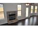 Cozy living room with a stone fireplace and hardwood floors, perfect for relaxation at 1530 Horseshoe Creek Ln, Cumming, GA 30041