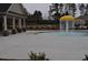 Community pool featuring a mushroom water feature and nearby clubhouse at 1530 Horseshoe Creek Ln, Cumming, GA 30041