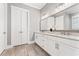 Bright bathroom features double vanity with granite countertops, white cabinets and tiled flooring at 1993 Haley Walk, Atlanta, GA 30318