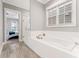 A luxurious bathroom with a soaking tub, white tile surround, and a glass-enclosed shower, a perfect space to unwind at 1993 Haley Walk, Atlanta, GA 30318