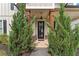 Charming entrance with a black door, wooden columns, and well-manicured landscaping for added curb appeal at 1993 Haley Walk, Atlanta, GA 30318