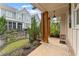 Charming front porch featuring brick accents, wooden pillars, and manicured lawn at 1993 Haley Walk, Atlanta, GA 30318