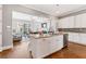 Open kitchen concept with a large island and stainless appliances looking into living room at 1993 Haley Walk, Atlanta, GA 30318