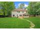 Spacious backyard features a patio, sunroom, and lush green lawn at 76 Barrington Farms Pkwy, Sharpsburg, GA 30277