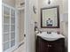Cozy half bathroom with a stylish vanity, modern fixtures, and a neutral color scheme at 76 Barrington Farms Pkwy, Sharpsburg, GA 30277