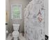 Full bathroom featuring decorative shower curtain and a window for natural light at 76 Barrington Farms Pkwy, Sharpsburg, GA 30277