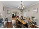 Open dining area featuring hardwood floors, a chandelier, and tastefully decorated walls at 76 Barrington Farms Pkwy, Sharpsburg, GA 30277
