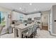 A well-equipped kitchen features white cabinetry, granite counters, and stylish island seating at 76 Barrington Farms Pkwy, Sharpsburg, GA 30277