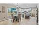 Bright eat-in kitchen with white cabinets, granite countertops, and stainless steel appliances at 76 Barrington Farms Pkwy, Sharpsburg, GA 30277