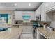 Bright kitchen featuring modern appliances, white cabinets, and granite countertops at 76 Barrington Farms Pkwy, Sharpsburg, GA 30277