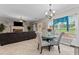 Cozy living area featuring a fireplace, tile flooring, and a breakfast nook with large windows at 76 Barrington Farms Pkwy, Sharpsburg, GA 30277