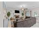 Inviting living room with a stone fireplace, comfortable sofa, and natural light at 76 Barrington Farms Pkwy, Sharpsburg, GA 30277