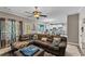 Spacious living room open to the kitchen, featuring a comfortable sectional and tile flooring at 76 Barrington Farms Pkwy, Sharpsburg, GA 30277