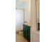 Bathroom featuring a green vanity with gold hardware and a nearby toilet at 351 Cherokee Ave, Atlanta, GA 30312