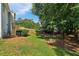 Backyard with grass, trees, wooden deck, and house with light blue siding at 3970 Genoa Ct, Duluth, GA 30096