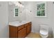 Bathroom with wood vanity, large mirror, bright lights and window at 3970 Genoa Ct, Duluth, GA 30096