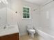 Bathroom featuring a white vanity, toilet, and shower with a window providing natural light at 3970 Genoa Ct, Duluth, GA 30096
