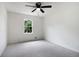 Spacious bedroom with neutral carpet, ceiling fan, and a window providing natural light at 3970 Genoa Ct, Duluth, GA 30096