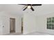 Bedroom with ceiling fan, window, and access to bath at 3970 Genoa Ct, Duluth, GA 30096