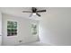 Bright bedroom with neutral carpet, ceiling fan, and natural light from two windows at 3970 Genoa Ct, Duluth, GA 30096