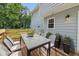 Outdoor dining set with table, chairs, and plants on a wood deck with light blue siding at 3970 Genoa Ct, Duluth, GA 30096