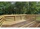 Wooden deck with wood railing has weathered wood and beams of sunlight coming through the trees at 3970 Genoa Ct, Duluth, GA 30096