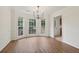 Charming dining room with hardwood floors, large windows, and a stylish chandelier at 3970 Genoa Ct, Duluth, GA 30096