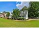 Well-manicured lawn and lush landscaping surround a two-story home with dormer windows at 3970 Genoa Ct, Duluth, GA 30096