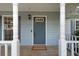 Front door with columns and welcome mat at 3970 Genoa Ct, Duluth, GA 30096
