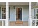 Inviting covered front porch with white columns, wood flooring, and a 'Welcome Home' doormat at 3970 Genoa Ct, Duluth, GA 30096