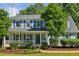 Charming two-story home with a covered front porch, blue shutters, and manicured landscaping at 3970 Genoa Ct, Duluth, GA 30096