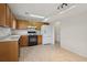 Efficient kitchen layout with wooden cabinets, tile flooring, and modern appliances, great for meal preparation at 3970 Genoa Ct, Duluth, GA 30096