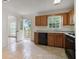 Bright kitchen with wooden cabinets, an access door to a deck, and tile flooring at 3970 Genoa Ct, Duluth, GA 30096