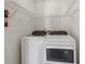Convenient laundry room featuring modern washer and dryer units with wire shelving at 3970 Genoa Ct, Duluth, GA 30096